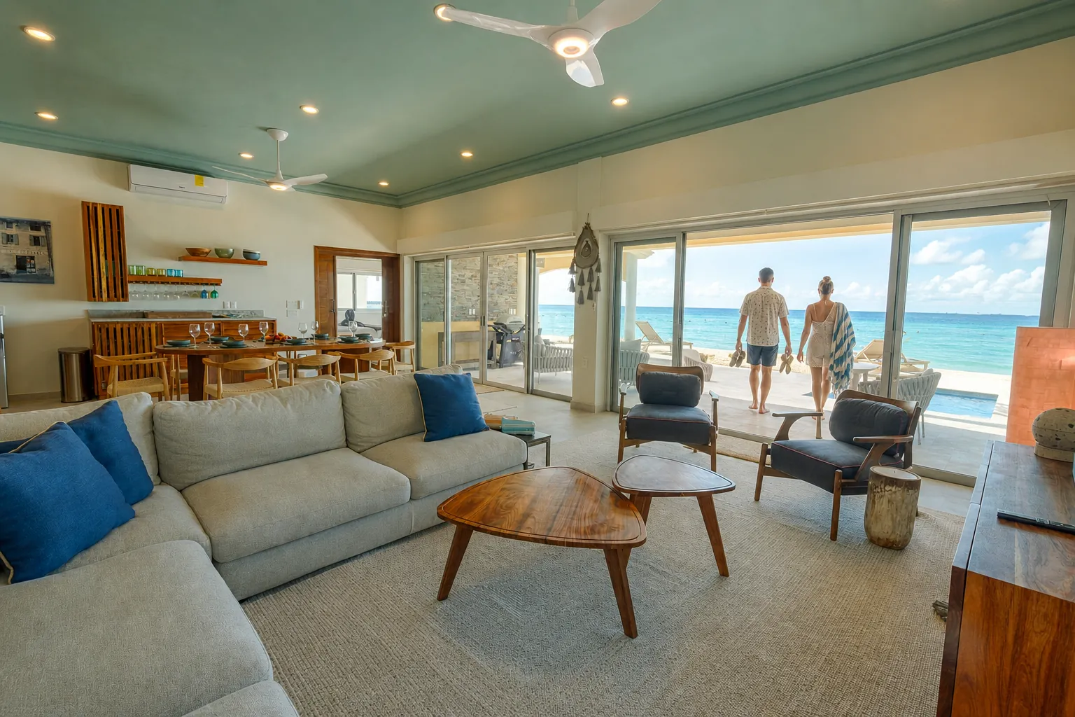 Casa Karma living room with sliding doors open to the beachfront terrace and Caribbean shoreline
