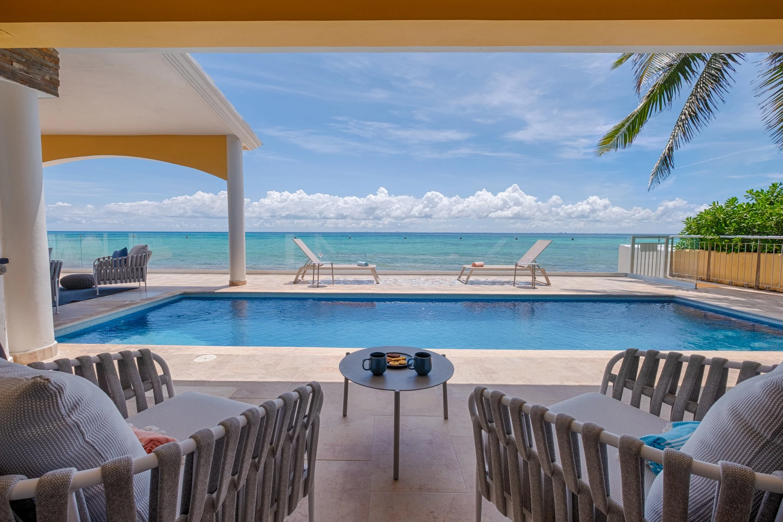 Poolside seating overlooking the Caribbean at Casa Karma